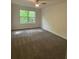 Spacious carpeted bedroom with large window at 101 Dancing Fox Rd, Decatur, GA 30032