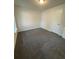 Cozy bedroom with gray carpeting, a bright window, and a white door at 101 Dancing Fox Rd, Decatur, GA 30032