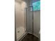 Modern shower stall featuring white tiled walls, glass doors, and a window providing natural light at 101 Dancing Fox Rd, Decatur, GA 30032
