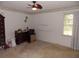This bedroom includes neutral carpet, ceiling fan, dresser and window with decorative trim at 1253 Gatewood Drive Dr, Lawrenceville, GA 30043