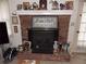 Classic brick fireplace with mantel, decorative items, and a black metal firebox at 1253 Gatewood Drive Dr, Lawrenceville, GA 30043