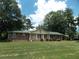 Charming brick home with green metal roof, front porch, and well-manicured lawn at 1253 Gatewood Drive Dr, Lawrenceville, GA 30043