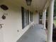 Covered front porch with columns, house number display, seating, and vintage lighting at 1253 Gatewood Drive Dr, Lawrenceville, GA 30043