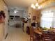 Cozy kitchen and dining area boasting white cabinets, a patterned floor, and classic floral wallpaper at 1253 Gatewood Drive Dr, Lawrenceville, GA 30043