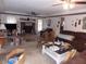 Spacious living room features a brick fireplace, ceiling fan, neutral carpet and classic border at 1253 Gatewood Drive Dr, Lawrenceville, GA 30043