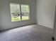 Serene bedroom with plush carpet and a window providing ample natural light at 169 Rachel Blvd, Temple, GA 30179
