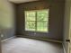 Cozy bedroom with neutral carpet and a window offering natural light and outdoor views at 169 Rachel Blvd, Temple, GA 30179