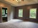 Spacious main bedroom with gray carpet, large windows, and an en-suite bathroom at 169 Rachel Blvd, Temple, GA 30179