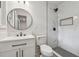 Bathroom featuring modern vanity, stylish lighting, walk-in shower with custom tile and trim at 4443 Flat Shoals Pkwy, Decatur, GA 30034