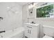 Updated bathroom featuring modern fixtures, sleek vanity, and elegant marble-style tile at 4443 Flat Shoals Pkwy, Decatur, GA 30034