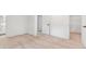 Bedroom with light wood floors, white walls, a closet and view into an en-suite bathroom at 4443 Flat Shoals Pkwy, Decatur, GA 30034