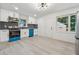 Renovated kitchen featuring stainless steel appliances, updated cabinetry, and new flooring at 4443 Flat Shoals Pkwy, Decatur, GA 30034
