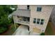 Aerial view of a brick home with a covered patio, two-car garage, and well-manicured lawn at 4895 Sterling Close, Buford, GA 30518