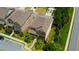 Aerial view of a well-maintained two-story home with a brown roof, landscaping and proximity to neighborhood amenities at 4895 Sterling Close, Buford, GA 30518