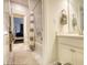 Bathroom featuring marble flooring, modern vanity, bath-shower combo with tile surround, and soft lighting at 4895 Sterling Close, Buford, GA 30518