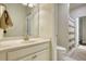 Bright bathroom featuring a single vanity, a well-lit mirror, and an adjacent toilet and shower area at 4895 Sterling Close, Buford, GA 30518