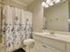 Cozy bathroom featuring a floral shower curtain and a single sink vanity at 4895 Sterling Close, Buford, GA 30518