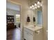 Cozy bathroom with a single vanity, mirror, and view to another room at 4895 Sterling Close, Buford, GA 30518