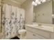 Cozy bathroom with floral shower curtain and white single sink vanity at 4895 Sterling Close, Buford, GA 30518