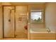 A bright bathroom featuring both a glass enclosed shower and a soaking tub at 4895 Sterling Close, Buford, GA 30518