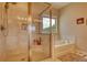 Bathroom featuring glass enclosed shower and soaking tub with a window view at 4895 Sterling Close, Buford, GA 30518