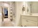 Bathroom featuring a single vanity and a shower with gray and white shower curtain beyond at 4895 Sterling Close, Buford, GA 30518