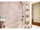Bathroom featuring a shower-tub combo with marble style tile, modern fixtures, and a shower curtain at 4895 Sterling Close, Buford, GA 30518