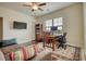 The bedroom is well-lit with a ceiling fan, a window with a view, and a desk for study at 4895 Sterling Close, Buford, GA 30518