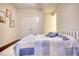 A bedroom featuring a bed with blue comforter, dark floors, and double doors at 4895 Sterling Close, Buford, GA 30518