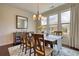 Bright dining room featuring large windows, a chandelier, and wood floors, creating a welcoming atmosphere at 4895 Sterling Close, Buford, GA 30518