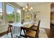 Inviting dining area featuring a chandelier, flowers, and large windows that provide abundant light at 4895 Sterling Close, Buford, GA 30518