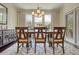 Inviting dining room with a modern chandelier, large windows, and stylish rug providing ample natural light at 4895 Sterling Close, Buford, GA 30518