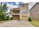 Charming home featuring a brick exterior, covered patio, and a convenient two-car garage at 4895 Sterling Close, Buford, GA 30518