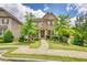 Beautifully landscaped two-story home with stone and siding exterior, and inviting front porch at 4895 Sterling Close, Buford, GA 30518