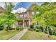 Attractive two-story home showcasing a well-manicured lawn, mature trees, and a welcoming porch at 4895 Sterling Close, Buford, GA 30518