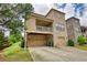 Stylish home features an elevated balcony over a two-car garage, complemented by a well-manicured lawn at 4895 Sterling Close, Buford, GA 30518