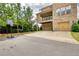 Attractive home with a two-car garage and balcony, adjacent to a basketball hoop and mature trees at 4895 Sterling Close, Buford, GA 30518