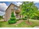Charming brick home featuring lush landscaping, a cozy front porch, and classic architectural details at 4895 Sterling Close, Buford, GA 30518