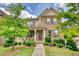 Charming two-story home with a stone and siding facade, beautiful landscaping and a welcoming front porch at 4895 Sterling Close, Buford, GA 30518