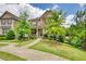 Charming two-story home with a stone and siding facade, beautiful landscaping and a welcoming front porch at 4895 Sterling Close, Buford, GA 30518