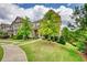 Charming two-story home with a stone and siding facade, beautiful landscaping and a welcoming front porch at 4895 Sterling Close, Buford, GA 30518