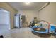 Open garage with speckled floors and all appliances, includes fridge, freezer and various playing accessories at 4895 Sterling Close, Buford, GA 30518