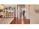 Hallway with hardwood flooring, white trim, and a built-in shelving unit with toy storage at 4895 Sterling Close, Buford, GA 30518