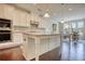 Bright kitchen featuring a large central island, stainless appliances, and an adjacent dining area at 4895 Sterling Close, Buford, GA 30518