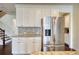 Kitchen area featuring stainless steel refrigerator, granite countertops, and tiled backsplash at 4895 Sterling Close, Buford, GA 30518