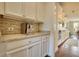 Kitchen area featuring granite counters, tiled backsplash, and stainless coffee machine at 4895 Sterling Close, Buford, GA 30518