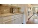 Kitchen area featuring cabinets, countertops, backsplash, and stainless coffee maker at 4895 Sterling Close, Buford, GA 30518