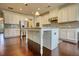 Bright, white kitchen with a center island, stainless steel appliances, and hardwood floors at 4895 Sterling Close, Buford, GA 30518