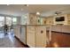 Open concept kitchen with island, breakfast bar, and view to the living and dining area at 4895 Sterling Close, Buford, GA 30518