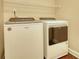 Laundry room with a white washer and dryer and wire rack shelving above at 4895 Sterling Close, Buford, GA 30518